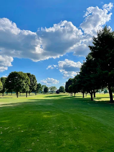 Wide-open fairway under blue summer skies